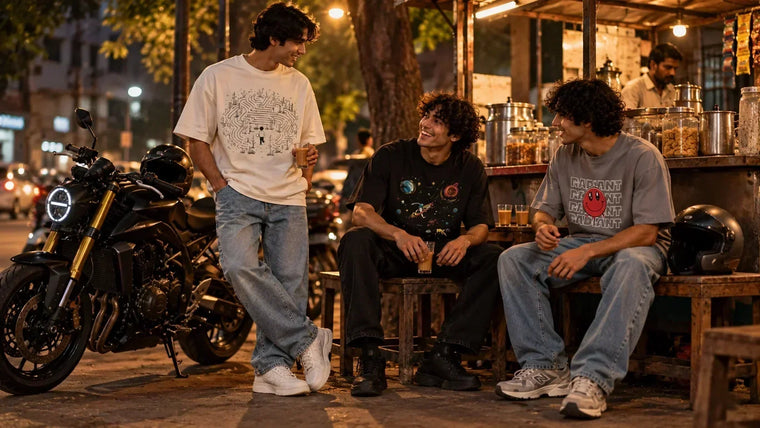 Men styling oversized graphic T-shirts with straight, black and relaxed-fit jeans